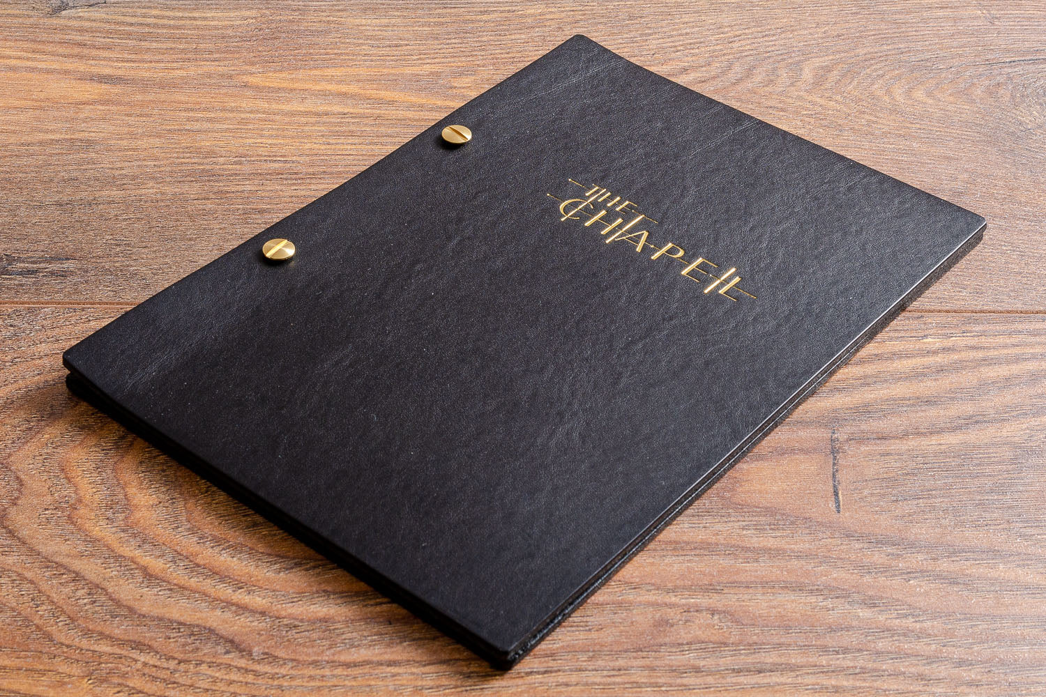 Black leather A5 drinks cocktail menu cover personalised with gold foil