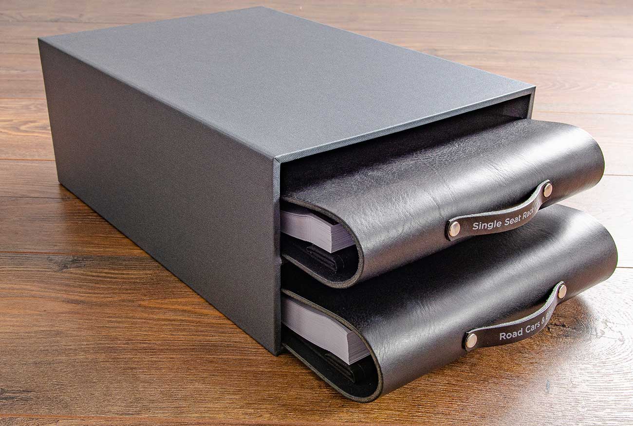 Two custom made leather binders inside a custom made slip case storage box