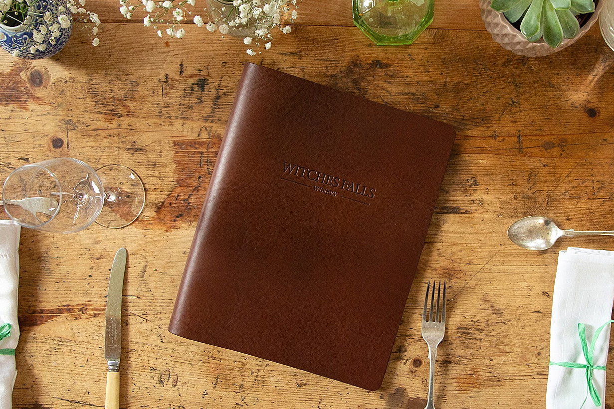 personalised leather menu cover on wooden dining table