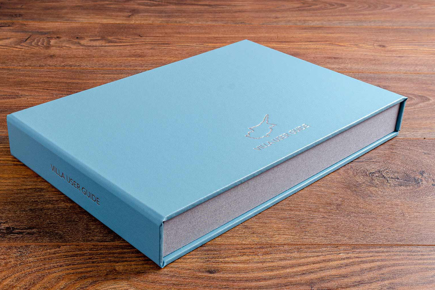 Custom made villa guest manual box file in blue buckram and personalised foil embossing