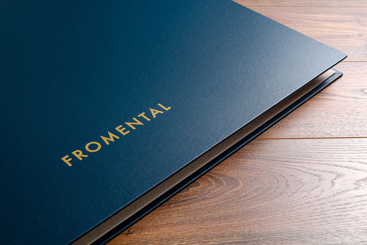 Personalised cover of A2 wall paper presentation swatch book in petrol blue buckram and gold foil personalisation