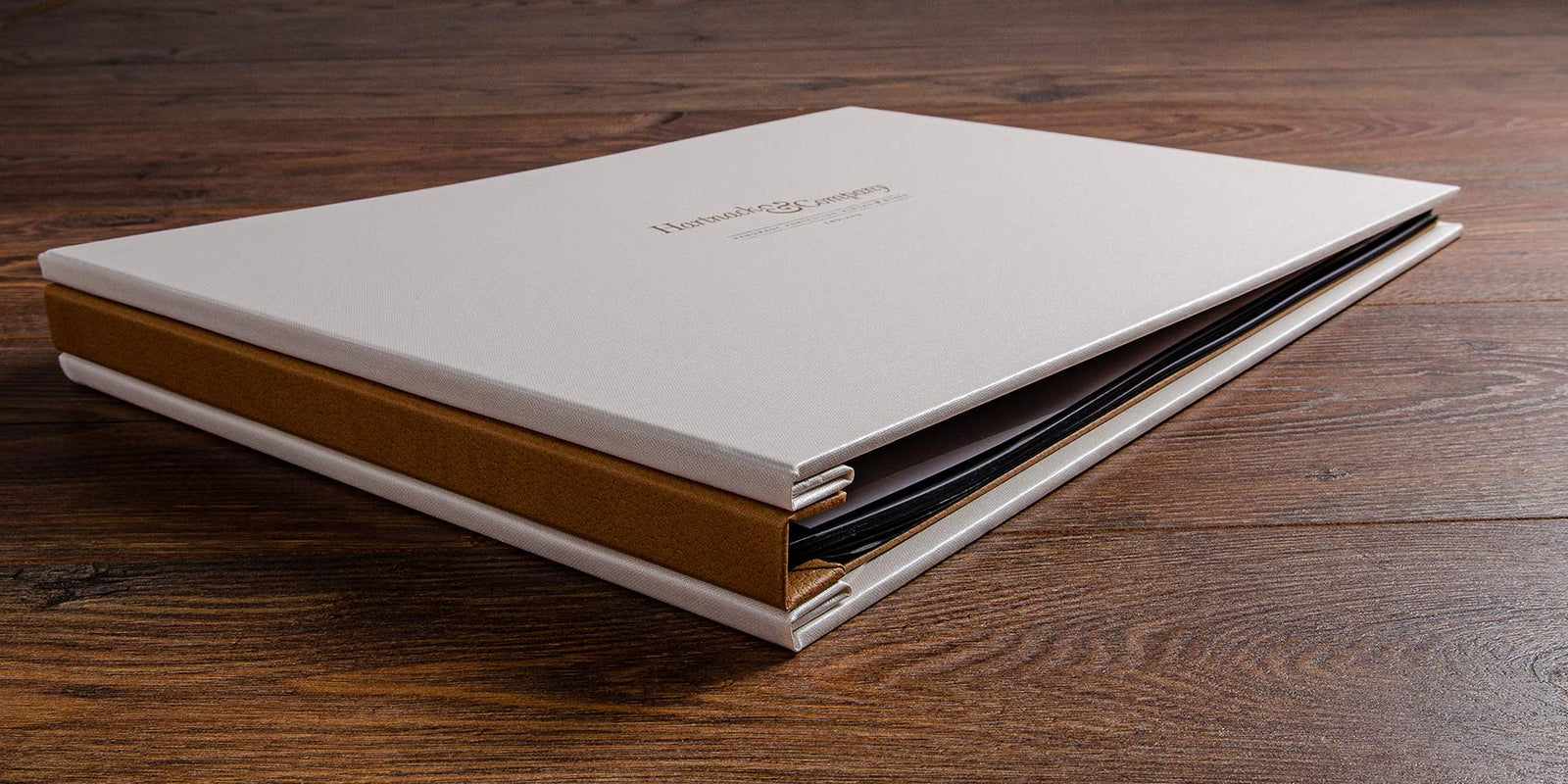 A photographers portfolio book with a personalised embossed cover