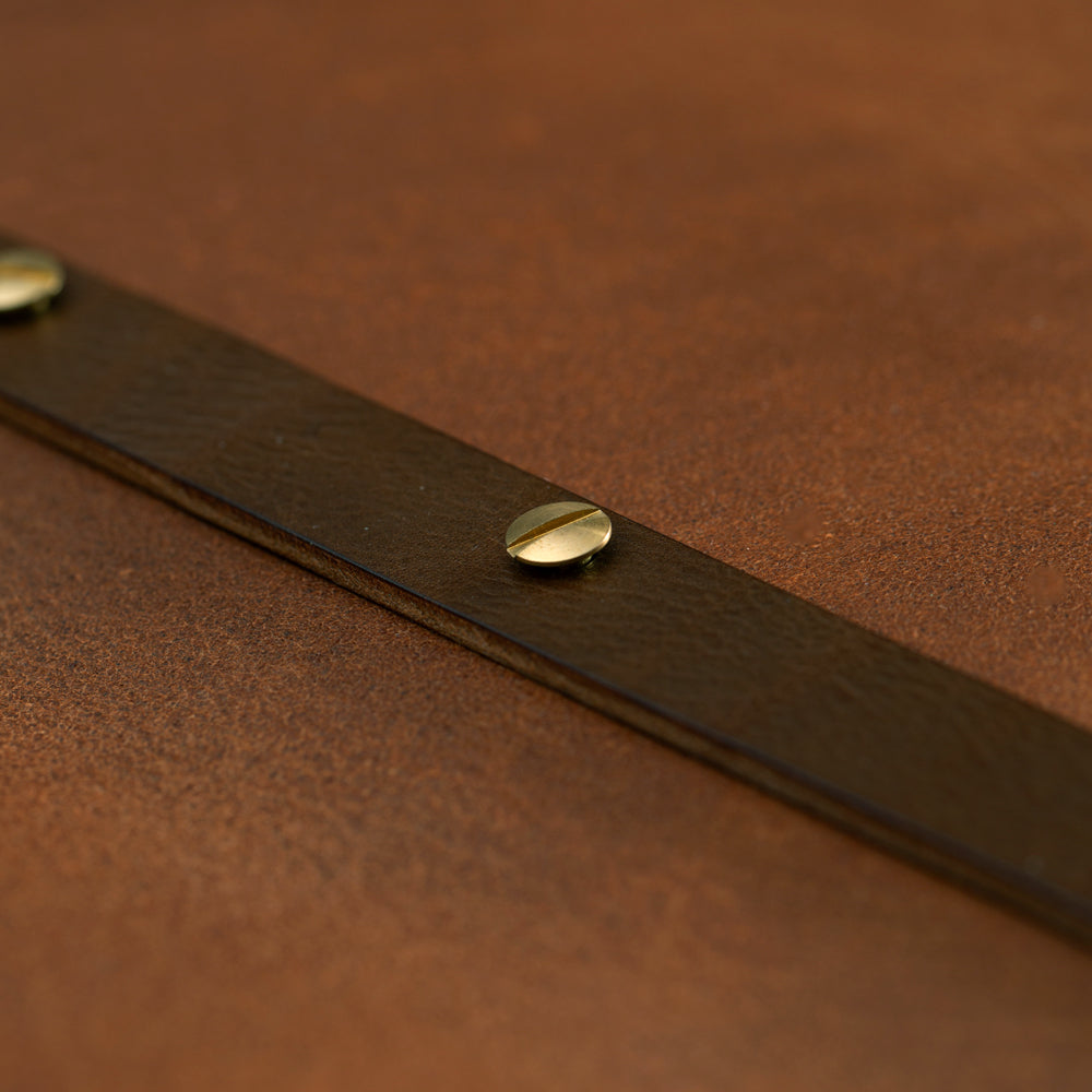 Close-up of Hartnack and Company Leather Screw Post Binder (PGB) in luxury veg tan leather with brass fastener detail.
