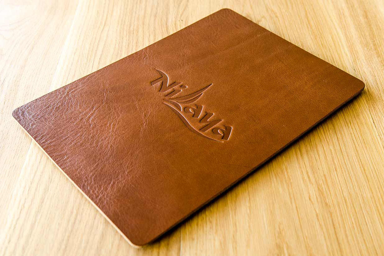 Personalised leather menu board in 3.5mm brown leather with embossed logo of luxury yacht