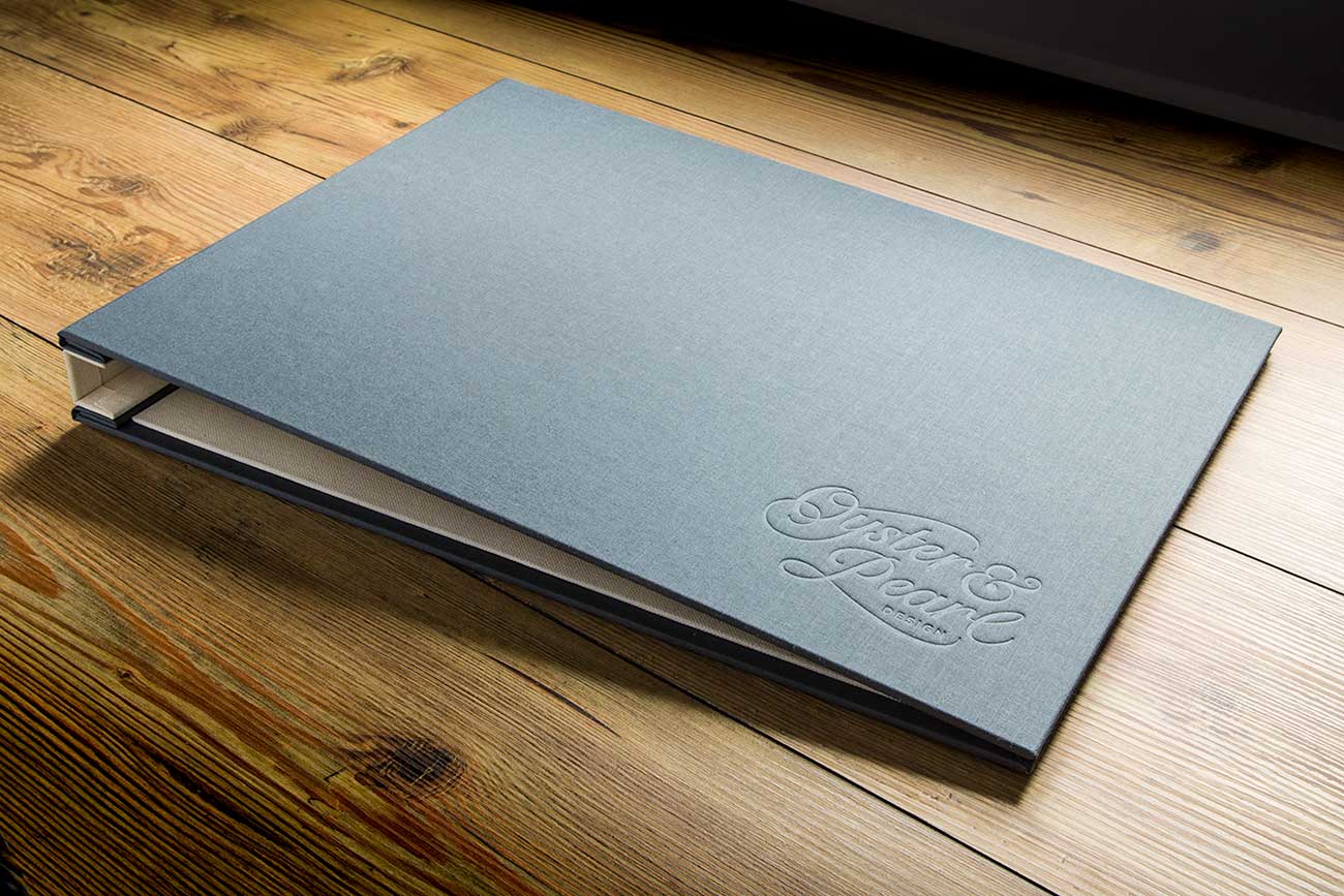 Graphic designers presentation portfolio, custom made by Hartnack and Co in grey book cloth and blind debossed cover