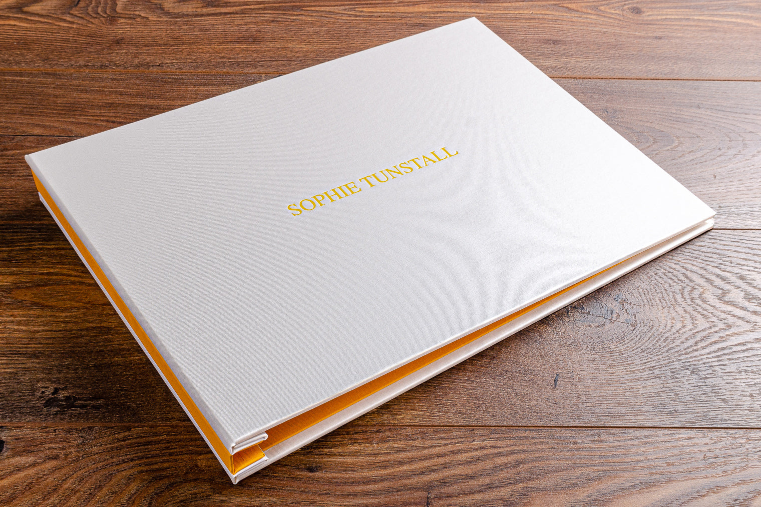 11x17 photography portfolio book in cool yellow and and white with yellow foil embossing