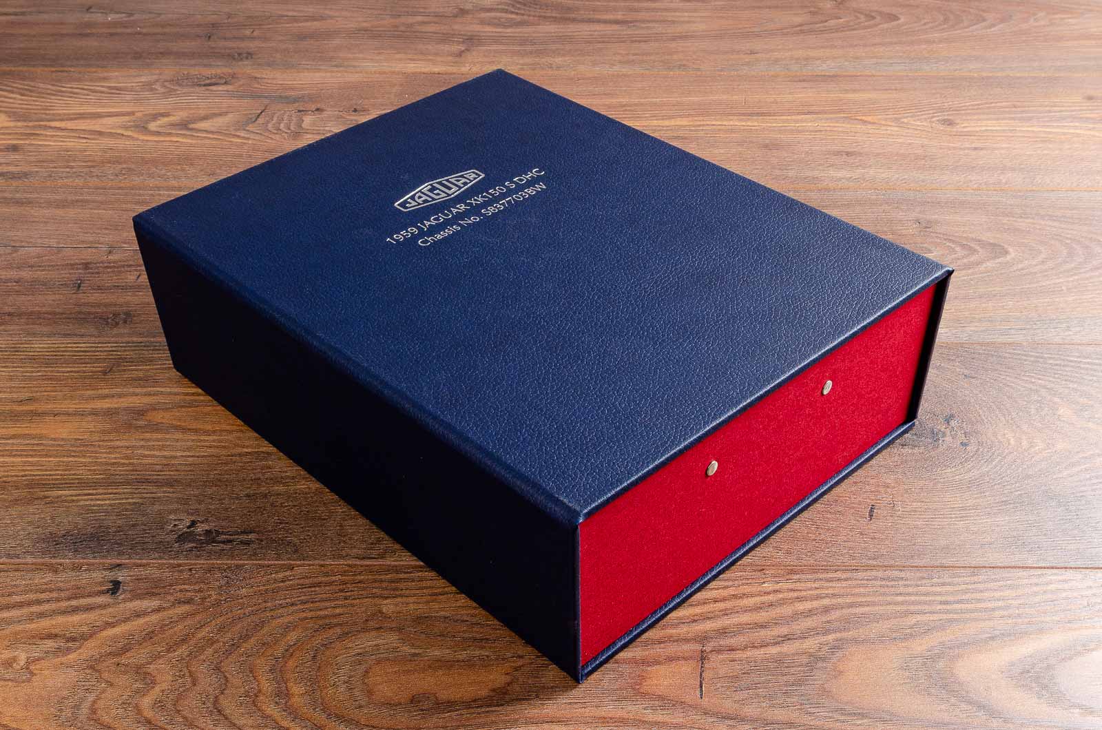 Blue faux leather and red cloth personalised box file with silver foil embossing. Made to the highest quality by hartnack and co