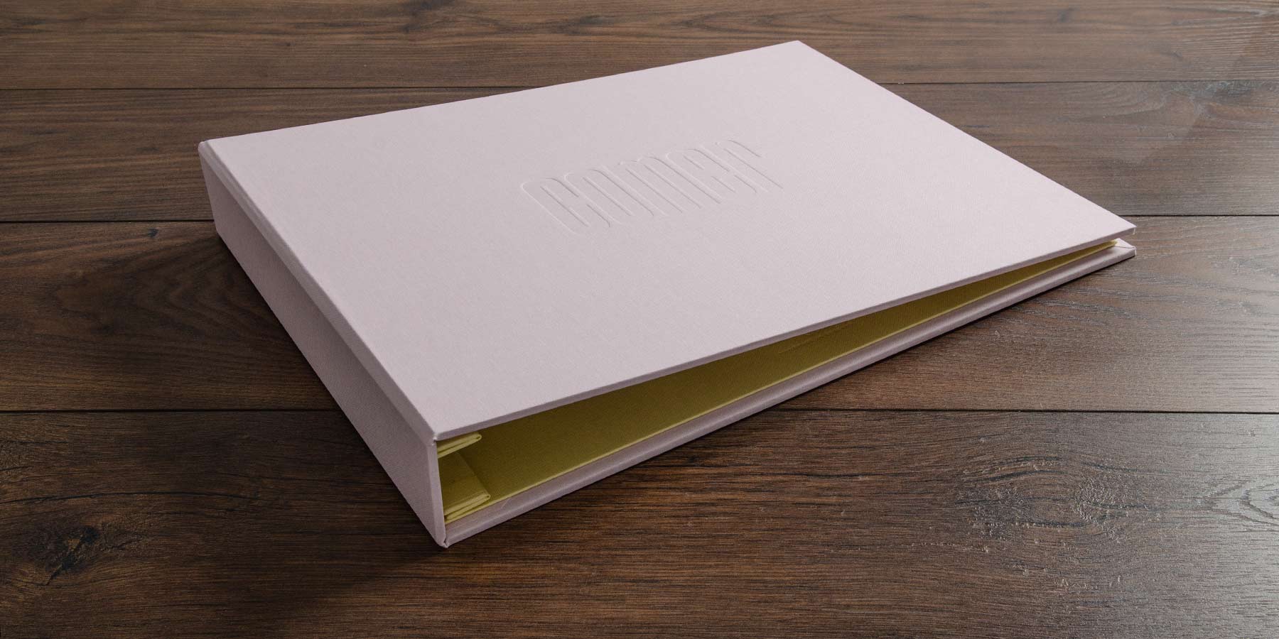 custom photography portfolio book in calamine and yellow backcloth for award winning photographer