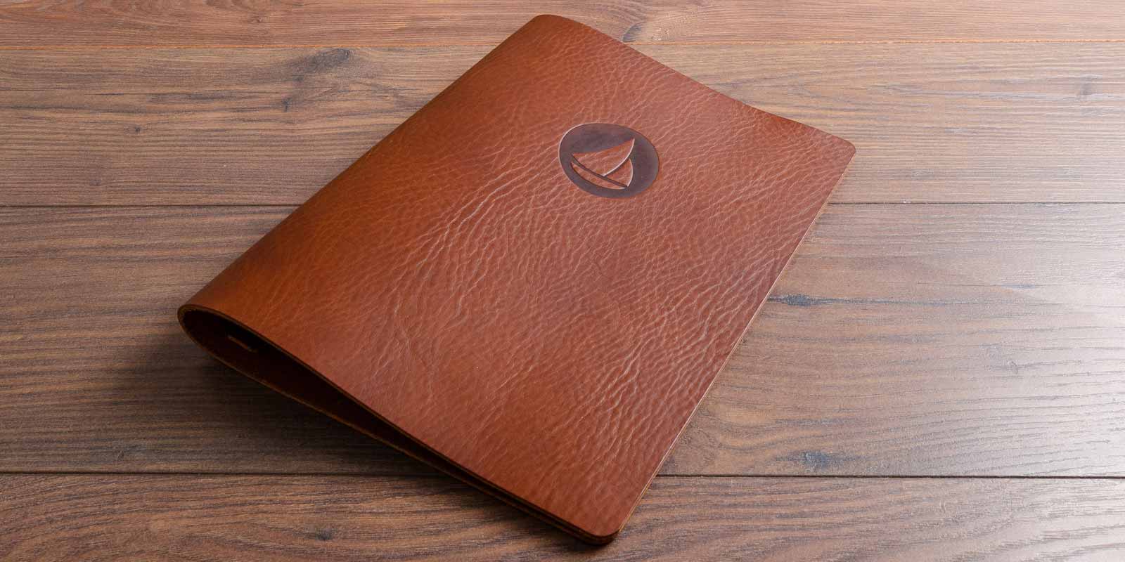 brown leather personalised menu with blind embossed branded logo hand made by hartnack and co