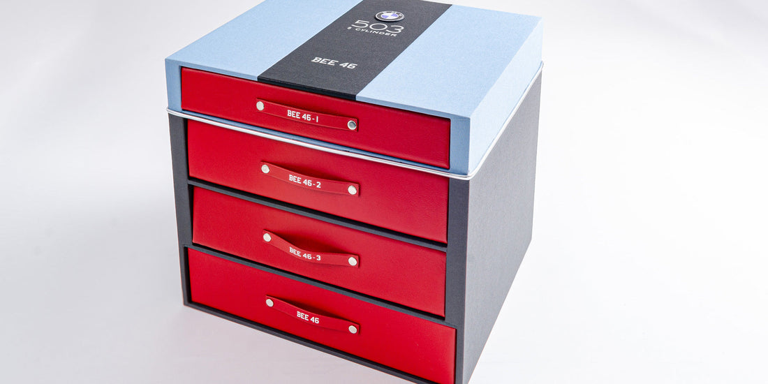Luxury car documentation box with a drawer and binder with blue, black and red leather