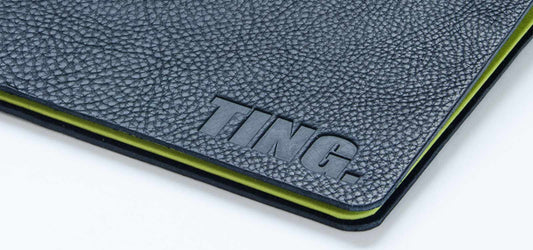 flip over portfolio book in black leather with embossed logo for fashion student