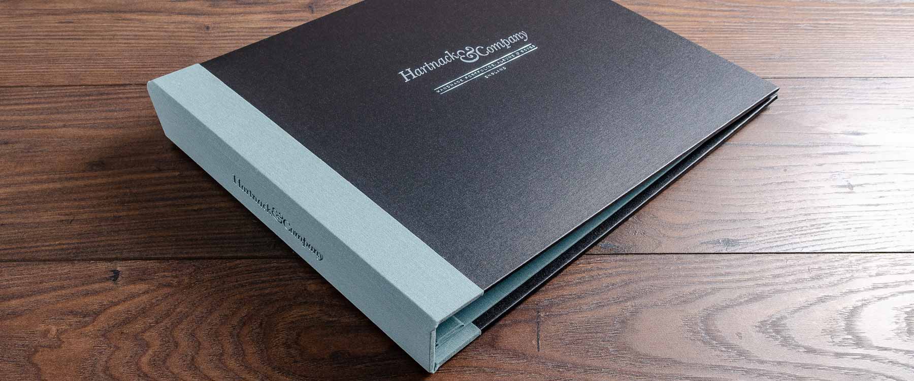 Personalised presentation portfolio in black book cloth with green foiling