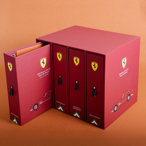 Red Ferrari-themed binder set for car documents personalised with illustration and logo on a brown background