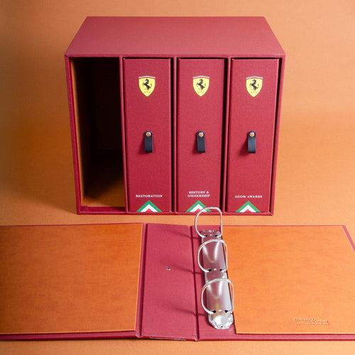 Red custom made three-ring binder with personalised logo of a car brand on an orange background