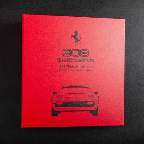 Red ring binder file for a Ferrari 308 with model details on the cover