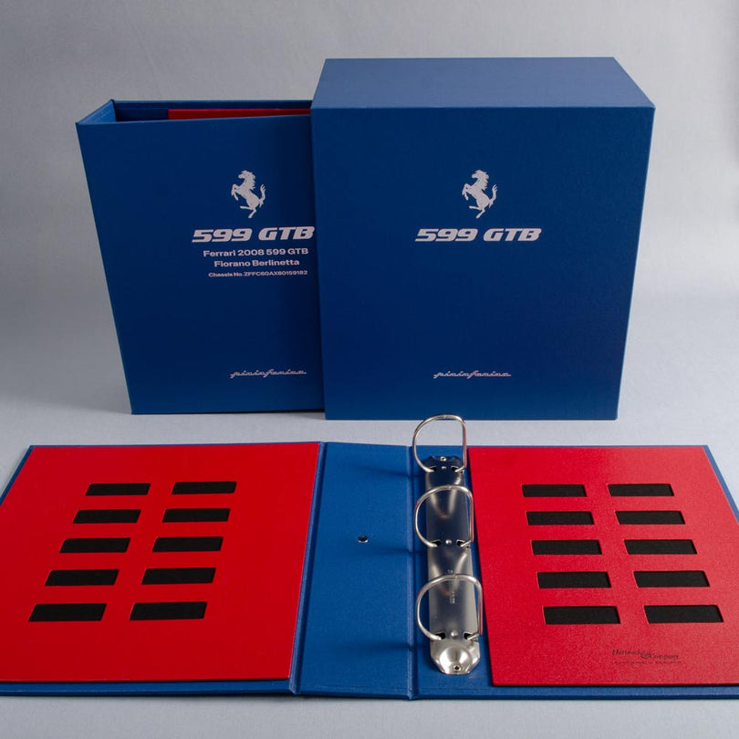 Custom made vehicle document box and binder in a blue and red box with silver foiled logo
