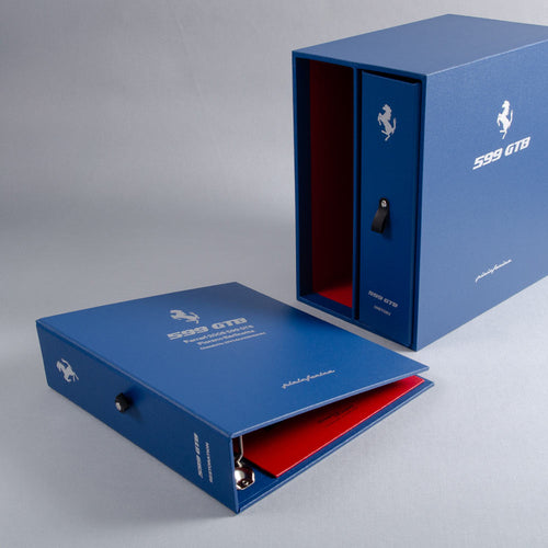 Blue Ferrari 599 GTB custom made box and ring binders with and personalised cover red interior on a gray background