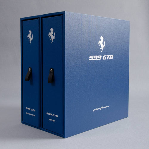 Blue Ferrari 599 GTB vehicle binder and box with brand logo on a gray background