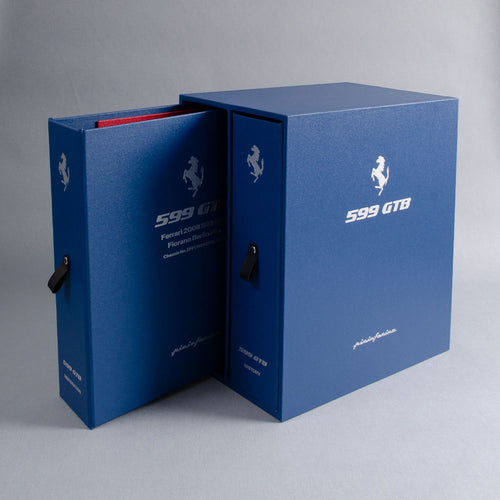 Blue 599 GTB document history binder and box with brand logo on a gray background