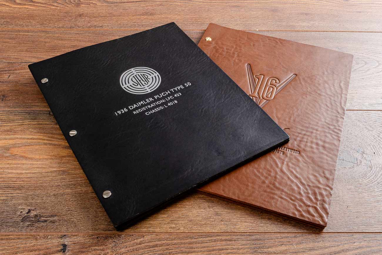 8.5 x 11" inch genuine leather binder in black and brown veg tan leather personalised with silver foil embossing and blind embossed personalisation