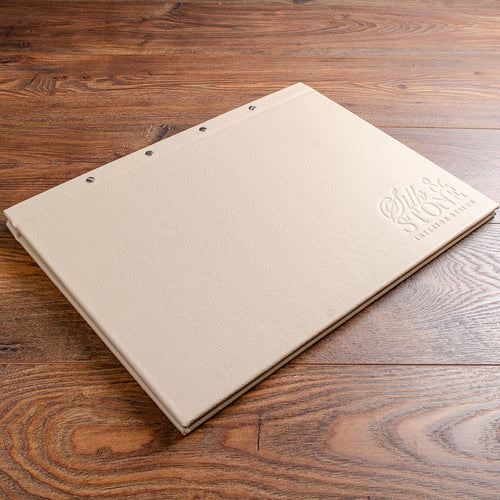 Luxury A3 leather presentation portfolio screw post binder in cream leather and blind embossed logo stamped into the cover