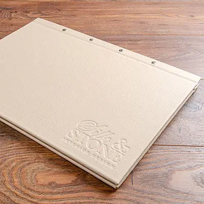 A3 luxury leather screw post portfolio binder in cream leather with blind embossed logo by Hartnack and Co