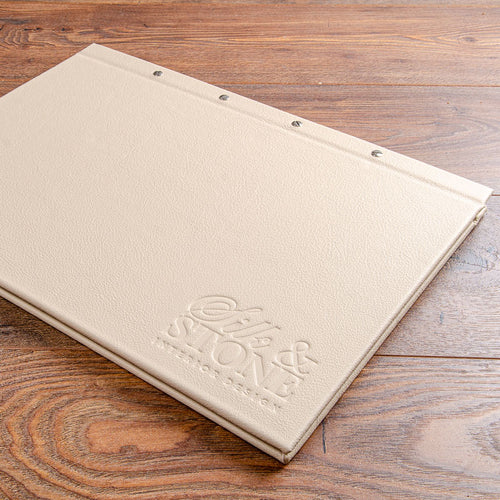 A3 luxury leather screw post portfolio binder in cream leather with blind embossed logo by Hartnack and Co