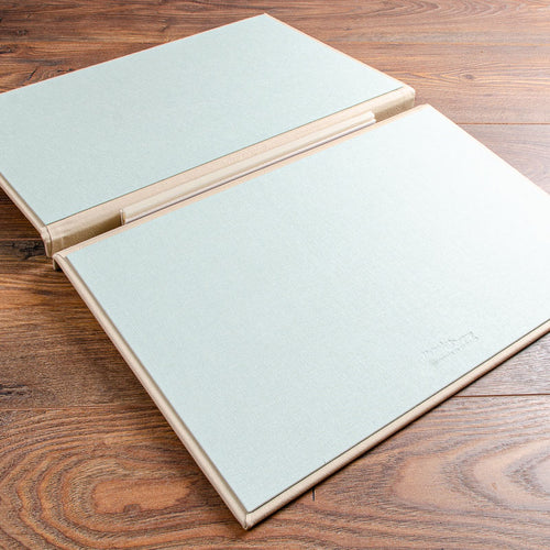 A3 luxury leather screw post binder opening up as flip over portfolio in light green fabric inner cover by Hartnack and Co