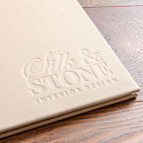 blind embossed logo in a leather presentation binder debossed into the cover