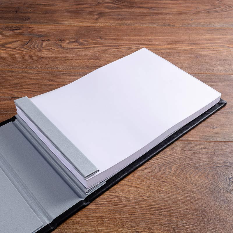 A4 white pages in a luxury hand made guest book binder with high quality white card stock that have been drilled and then scored. The pages have been inserted into the guest book with crew posts and hinge at the spine. 