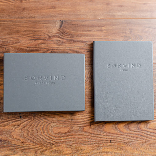 Custom made leather guest book and menu for luxury yacht with personalised embossed cover