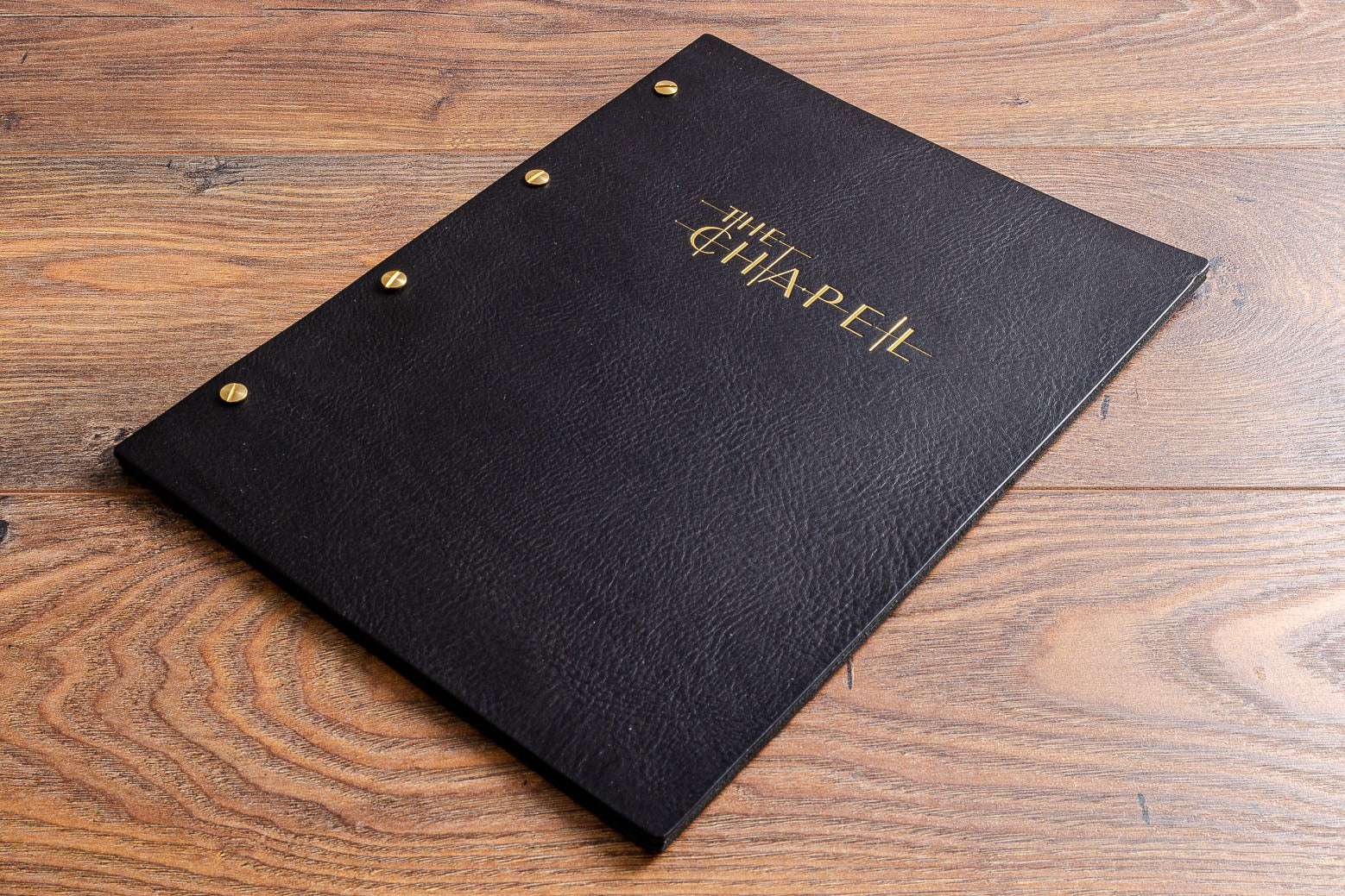 A4 black leather screw post menu cover personalised with gold foil