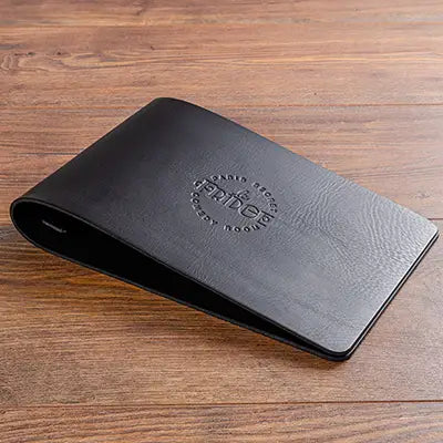 Personalised black leather menu cover with blind embossed logo on the cover