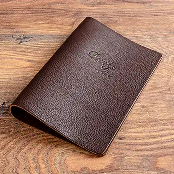 A5 genuine leather drinks and menu holder with elastic cord and debossed logo on the cover