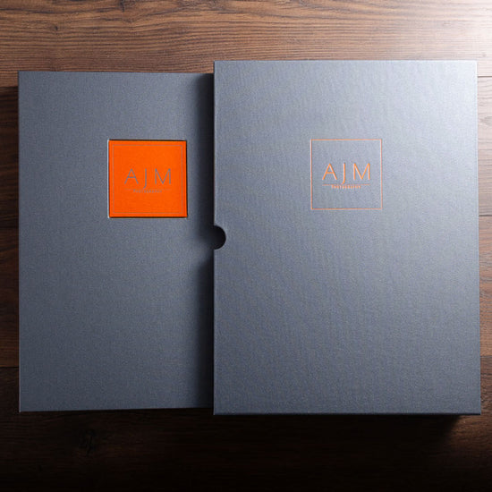 Custom made A3 portrait portfolio book and matching slipcase in grey buckram with orange foil embossed cover