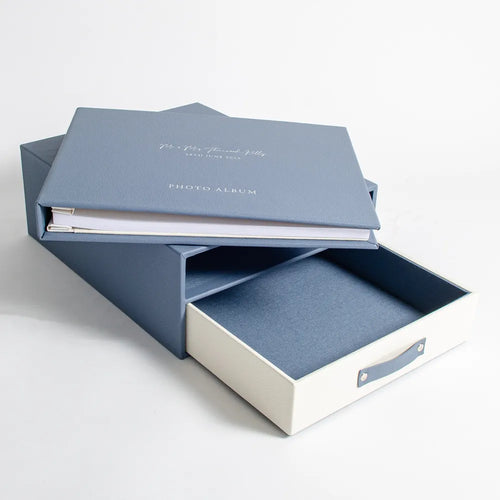 Blue leather wedding photo album personalised with foil embossed cover sitting on keepsake box with drawer 
