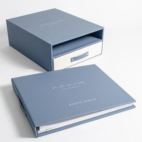 A blue leather wedding photo album binder and its matching storage box with drawer. Both the album and the box have foil embossed personalised covers