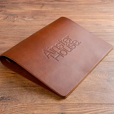 Beautiful leather menu cover personalised with logo embossed vertically on the cover