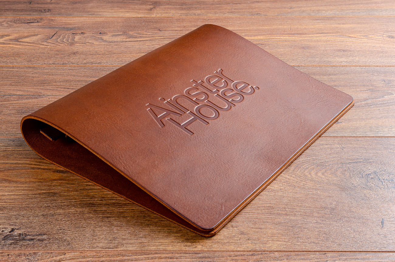 Beautiful leather menu cover with logo embossed vertically on the cover