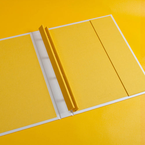 luxury custom made screw post binder for photography portfolio book in yellow and white by Hartnack and Co