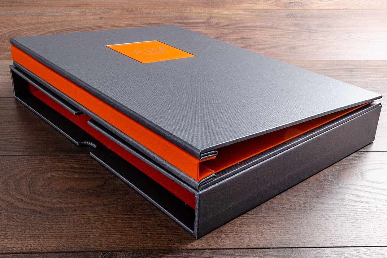 A3 photography portfolio book with matching slipcase. H&Co product is a Hidden screw post binder with optional name plaque in matching orange wit silver foil personalisation. Matching slipcase with matching lined interior and finger notches