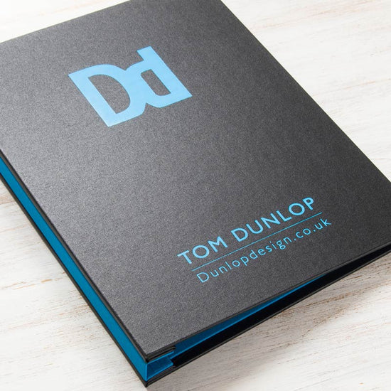 Black and blue A4 presentation portfolio binder with blue foiled logo embossed on the cover