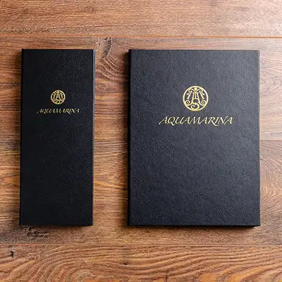 A4 and half A4 luxury menu covers in black vegan leather personalised logo in gold foil