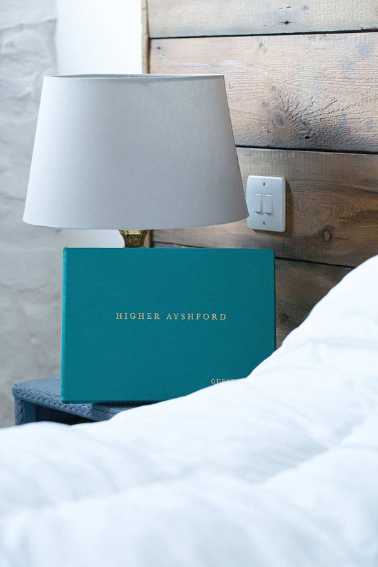 blue leather personalised guest book sitting on bedside table