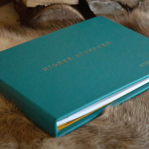 Luxury leather bound guest book in blue green leather with gold foil embossing