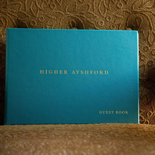 Luxury leather bound guest book with gold foil embossing on the cover of a beautifully hand made product by hartnack and company