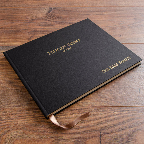 Personalised guest book in black book cloth with gold embossed cover.