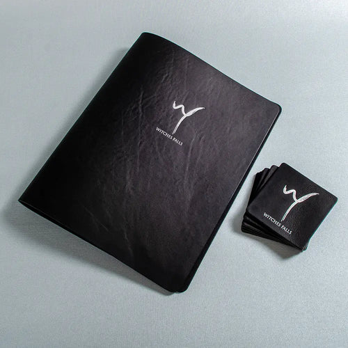 Black leather A4 menu cover with silver foil embossed personalised cover together with  square leather coasters drinks mats