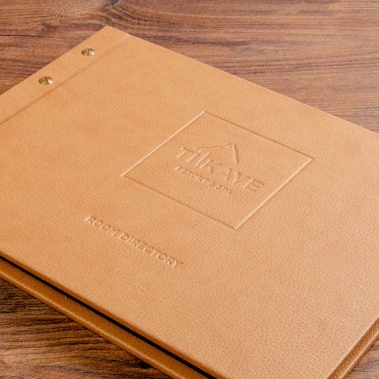 Blind emboss example on the personalised cover of a hotel room directory binder