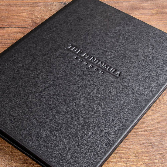 Luxury leather menu cover in black leather  with a personalised logo blind embossed into the the cover